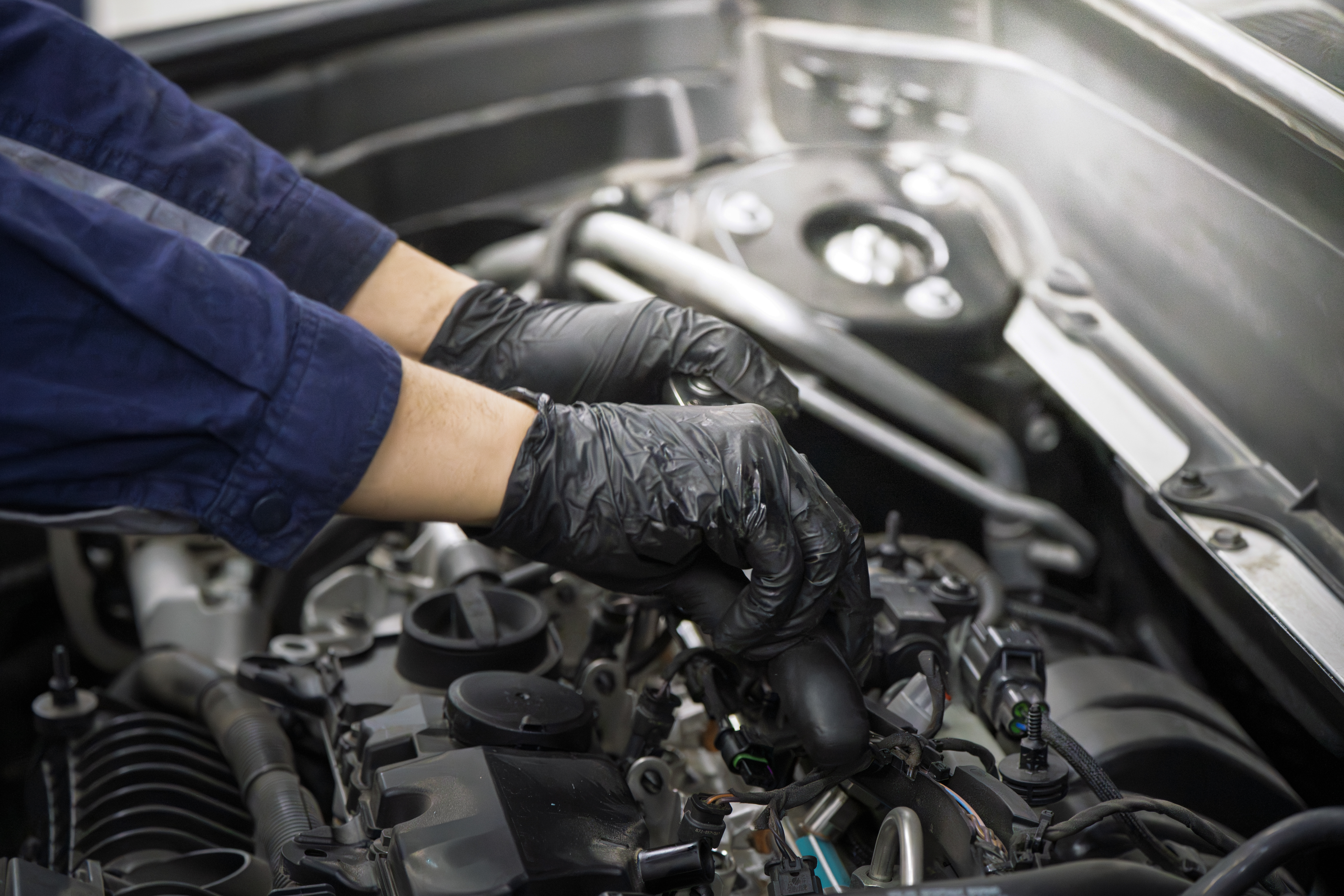 Mechanic Wearing Black Gloves Repairs Car Engine